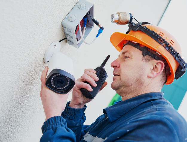 maintenance worker checking on security system